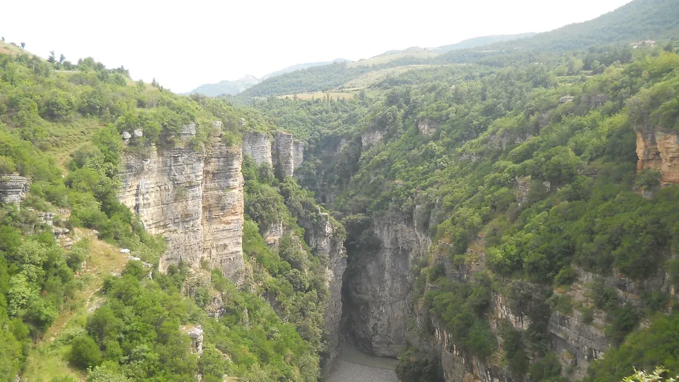 Osumi Canyon's limestone walls rising above the dry riverbed, seen from the rim
