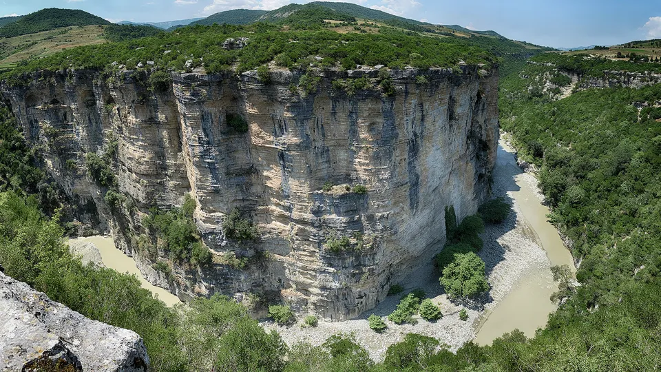 Wide view of the Osumi River winding between the canyon's limestone cliffs
